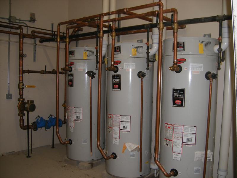 Three water heaters in a commercial setting for blog "Commercial Property Management"