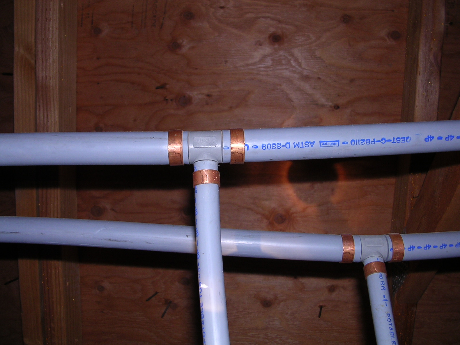 Two polybutylene pipes with copper seals for blog "Home Repiping in Ahwatukee"
