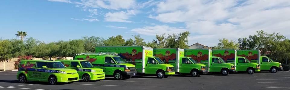 8 Robins Plumbing vehicles lined up in a row