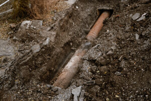 Cover photo of a sewer line for blog "What Backs Up a Sewer Line?"