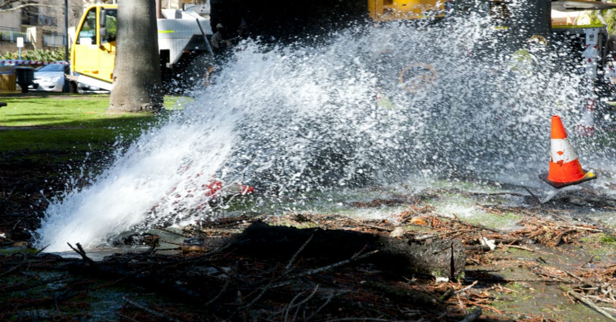 A burst pipe spraying water onto a city street