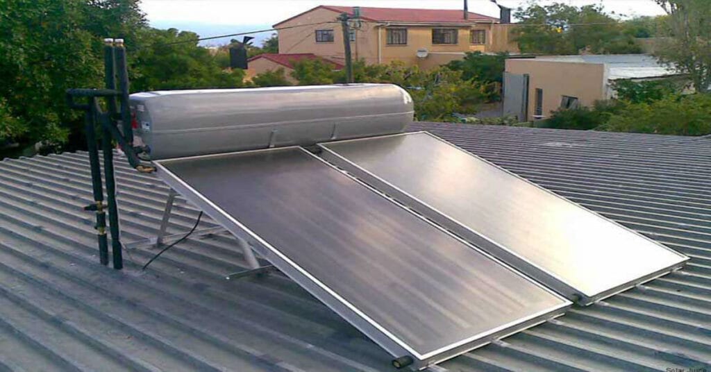 A solar water heater on top of the roof of a home.