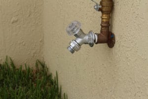 A hose bibb outside of a home.