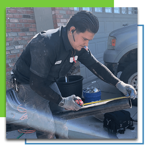 A picture of a plumber that works for Robins Plumbing measuring pipe.