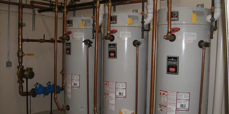 Three water heaters in a commercial setting for blog "Commercial Property Management"