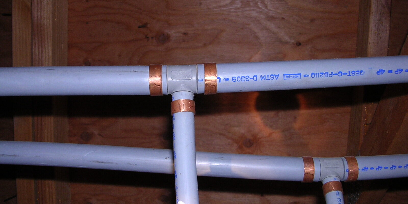 Two polybutylene pipes with copper seals for blog "Home Repiping in Ahwatukee"