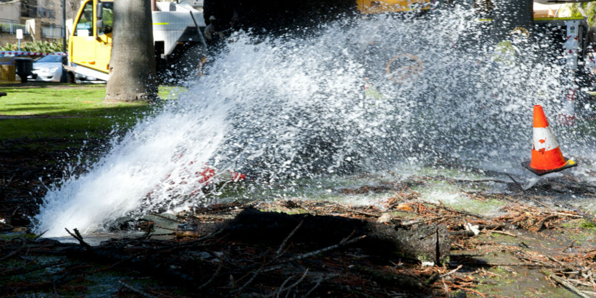A burst pipe spraying water onto a city street